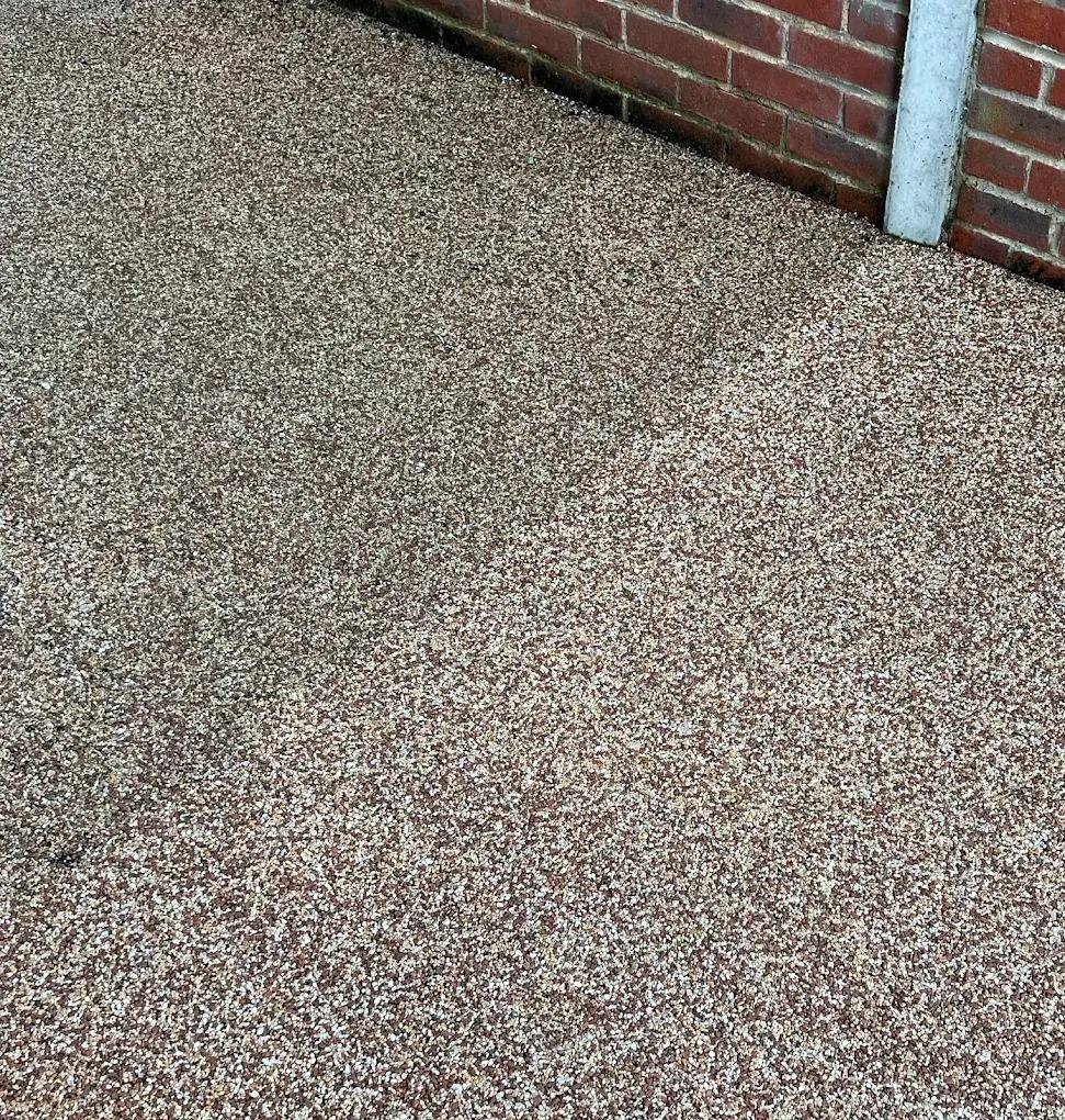 Resin driveway mid-clean showing the contrast between the washed and unwashed sections