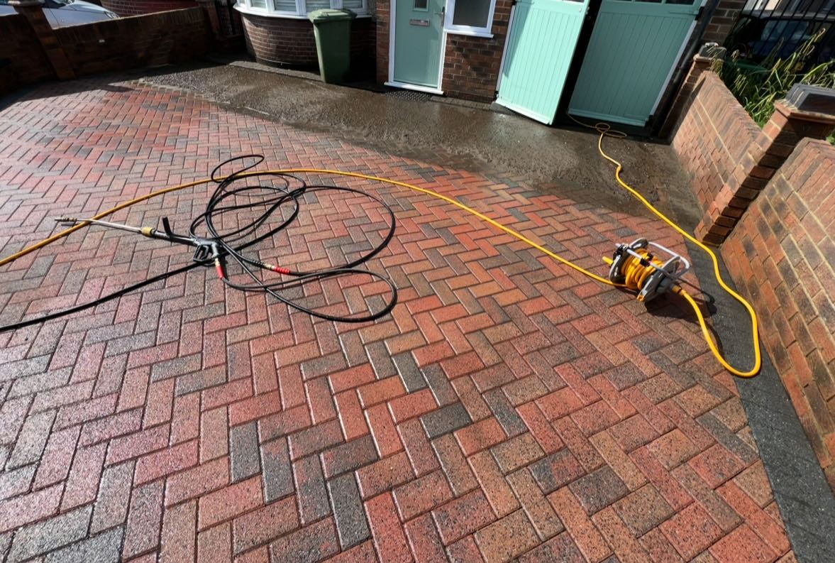 Wide block paving driveway freshly pressure washed outside a Bexley home