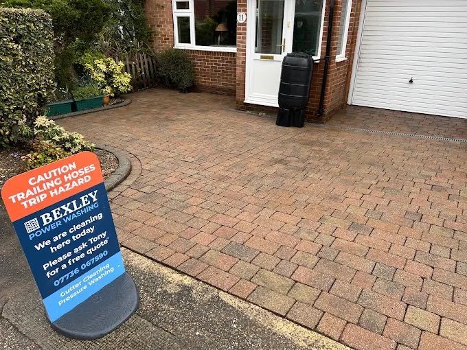 Bexley Power Washing safety signage outside a house on a driveway cleaning job